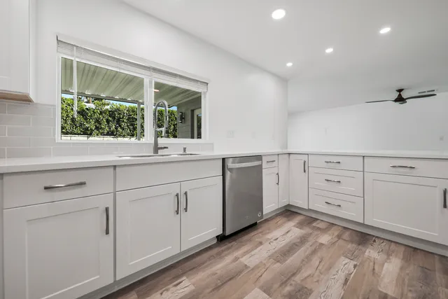 a view of a sink and dishwasher with window