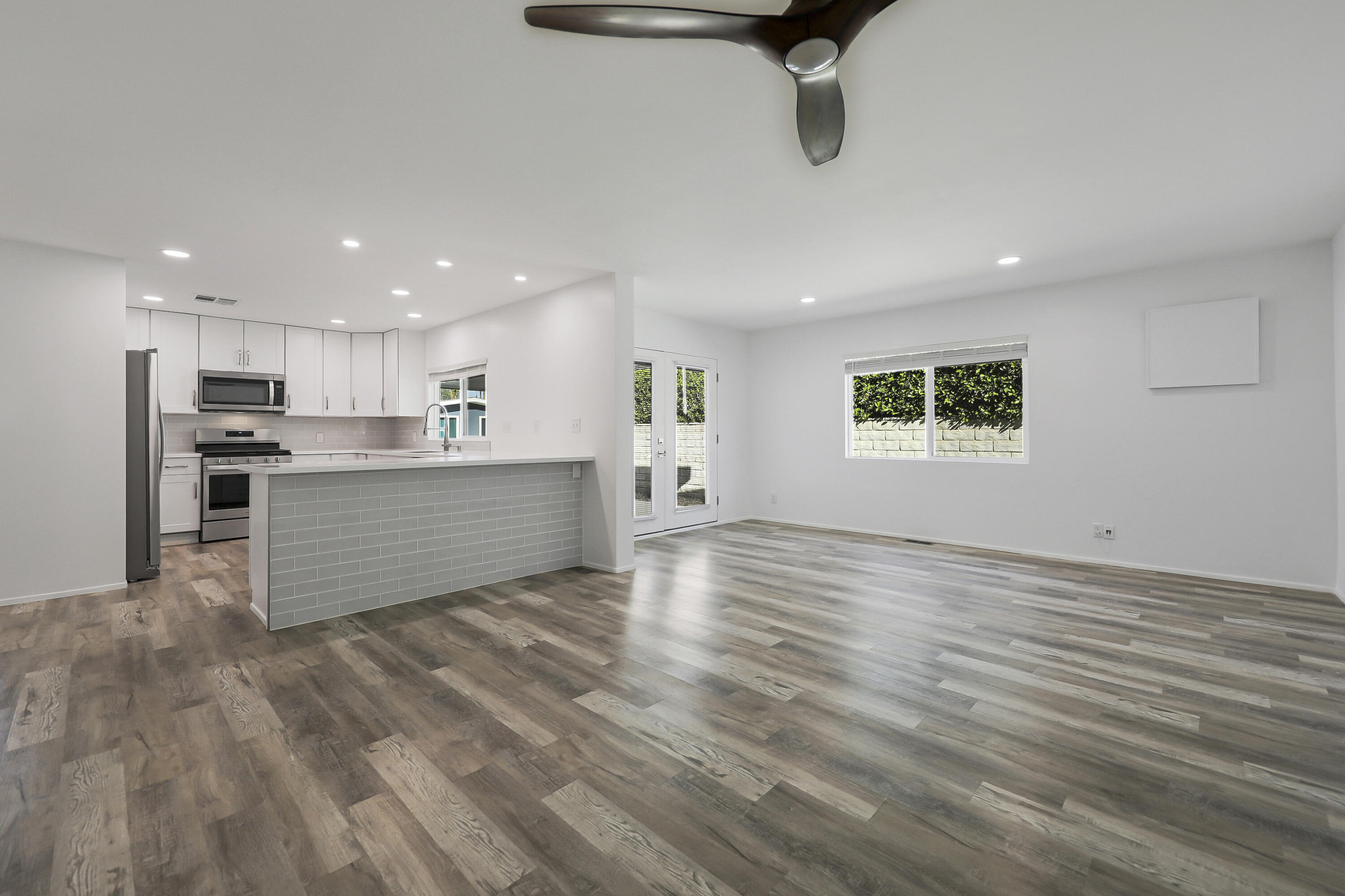 126 Monte Carlo Street Rancho Mirage, CA 92270 - Photo 15 of 33 a view of kitchen and empty room with wooden floor and windows