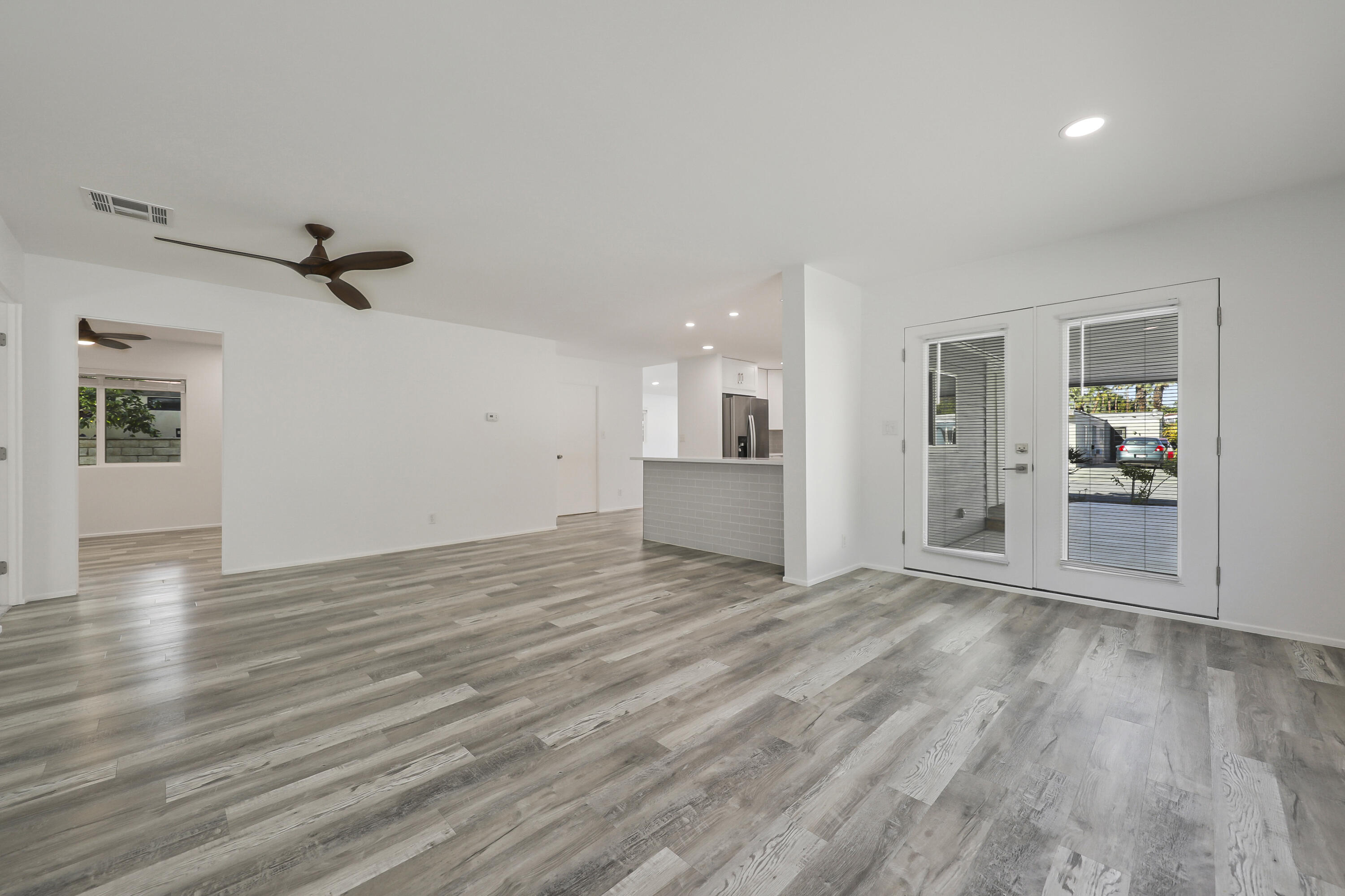 126 Monte Carlo Street Rancho Mirage, CA 92270 - Photo 16 of 33 a view of a livingroom with wooden floor and a ceiling fan
