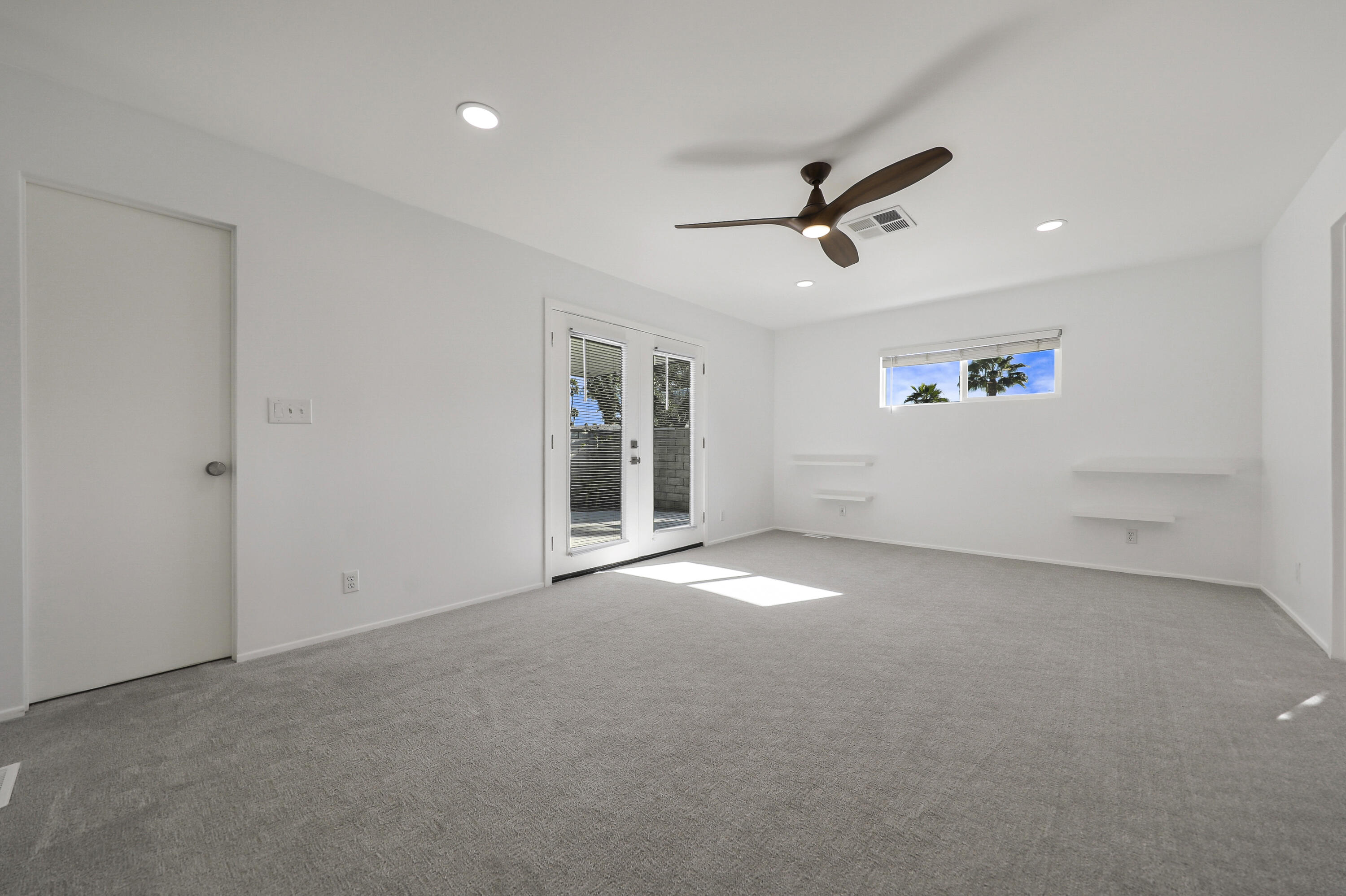126 Monte Carlo Street Rancho Mirage, CA 92270 - Photo 18 of 33 an empty room with windows and fan