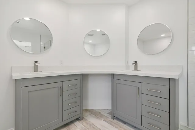 a bathroom with a double vanity sink and a mirror