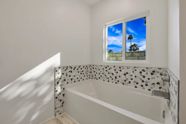 a bathroom with a bathtub and a shower