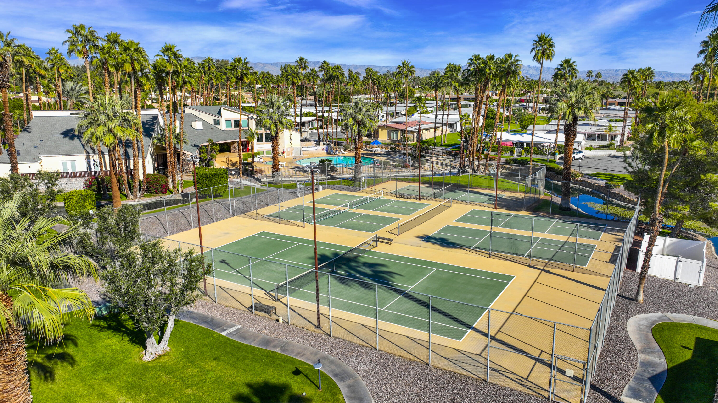 126 Monte Carlo Street Rancho Mirage, CA 92270 - Photo 31 of 33 a view of a tennis ground with large trees