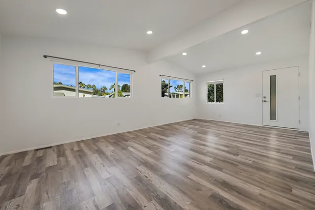 a view of a room with wooden floor and window