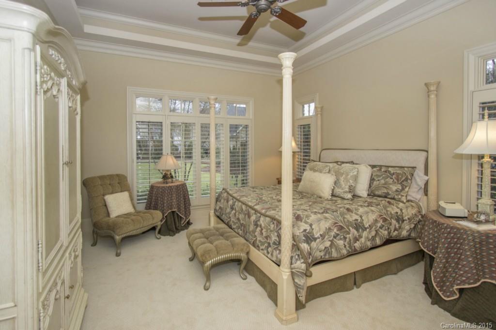 1930 Harris Road Charlotte, NC 28211 - Photo 14 of 21 a bedroom with a bed and a chandelier