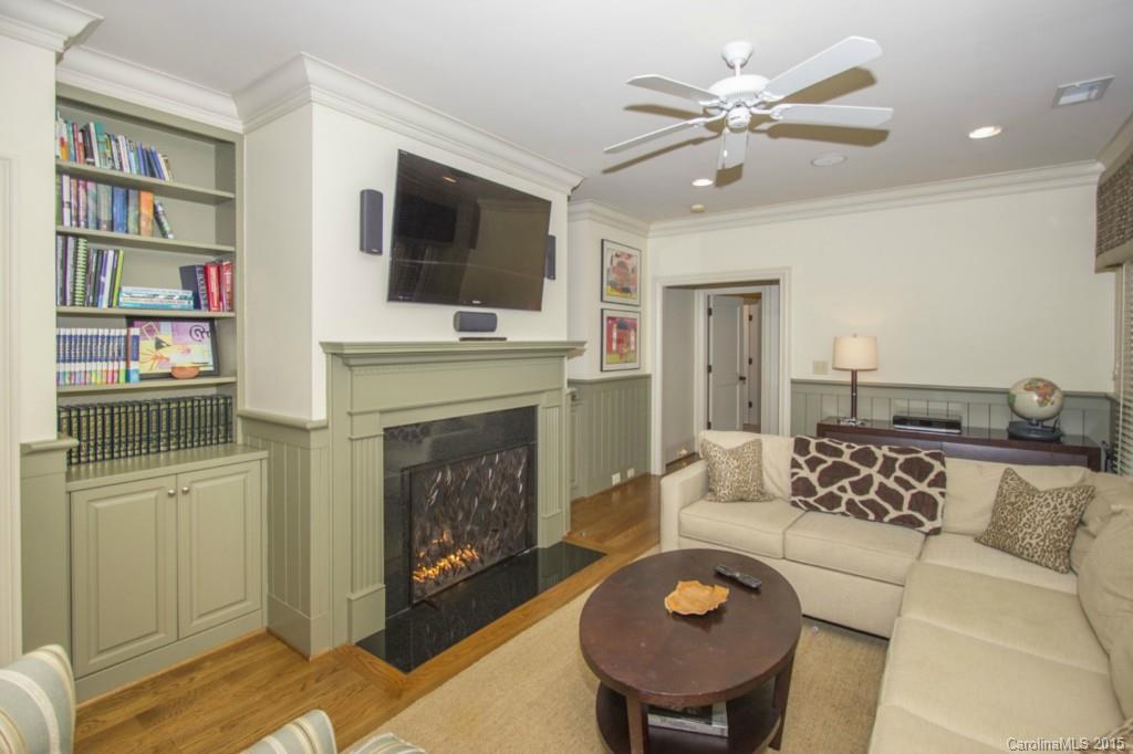 1930 Harris Road Charlotte, NC 28211 - Photo 16 of 21 a living room with furniture a flat screen tv and a fireplace