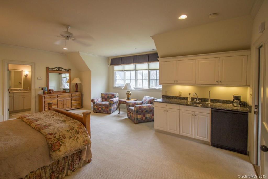 1930 Harris Road Charlotte, NC 28211 - Photo 19 of 21 a large bedroom with kitchen island granite countertop lots of white cabinets stainless steel appliances