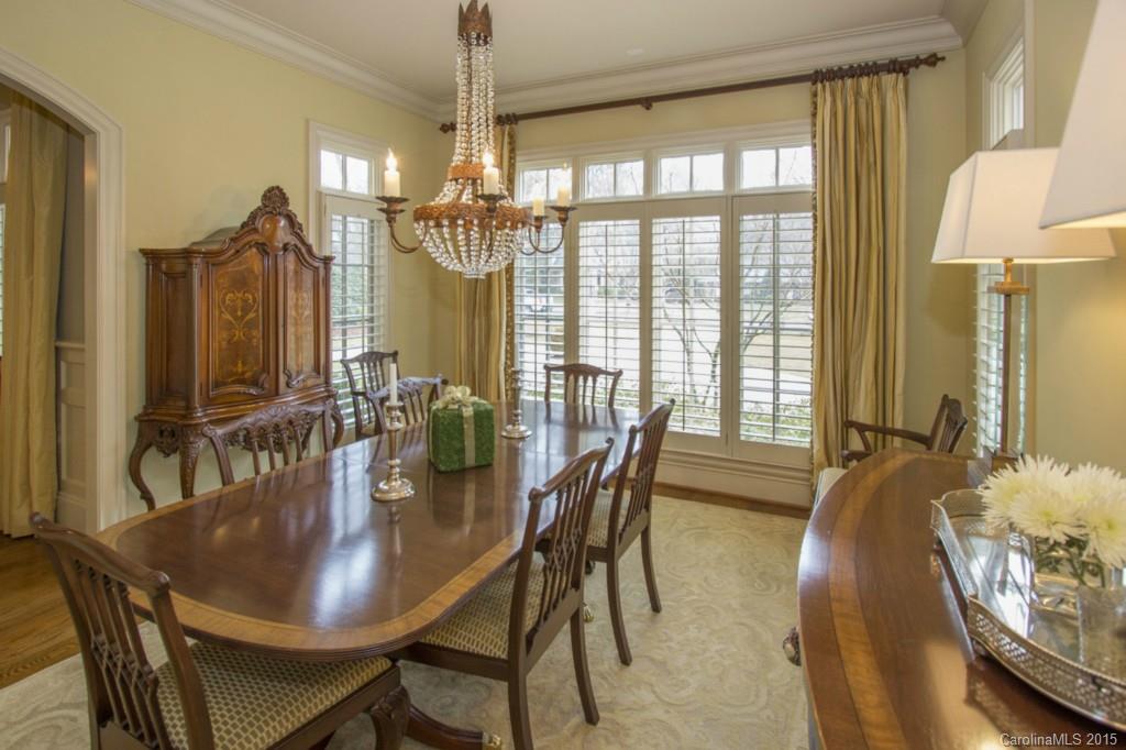 1930 Harris Road Charlotte, NC 28211 - Photo 9 of 21 a dining room with furniture a chandelier and wooden floor