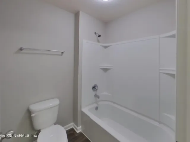a bathroom with a toilet and a bathtub