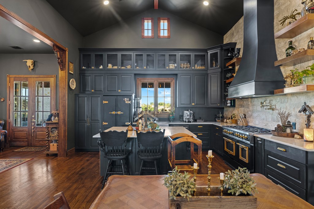 162 Flowering Sage Lane Comfort, TX 78013 - Photo 13 of 74 a kitchen with stainless steel appliances granite countertop a stove top oven a sink dishwasher and cabinets with wooden floor