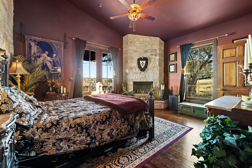 162 Flowering Sage Lane Comfort, TX 78013 - Photo 27 of 74 a bed room with a bed and a fireplace