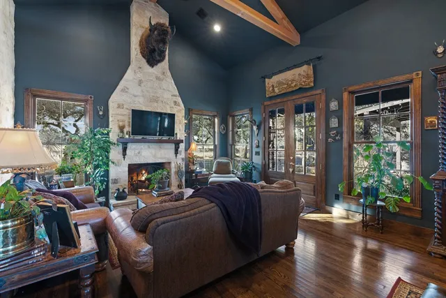 a living room with furniture fireplace and potted plants