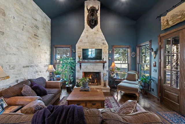 a kitchen with stainless steel appliances granite countertop a stove a sink dishwasher and cabinets with wooden floor