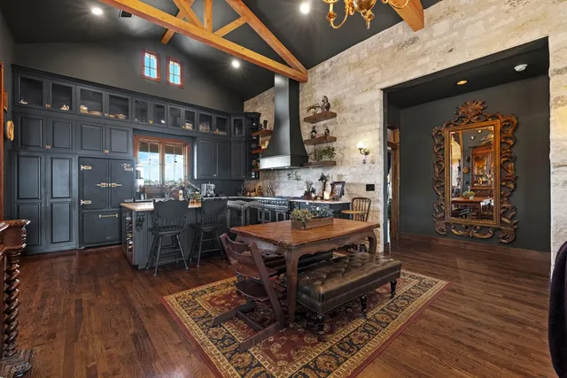 a kitchen with stainless steel appliances granite countertop a stove top oven a sink dishwasher and cabinets with wooden floor