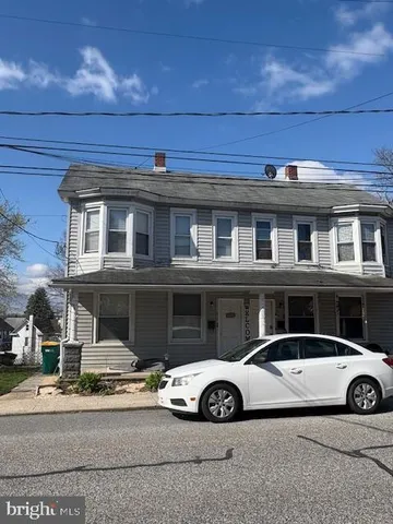 a front view of a house with parking space