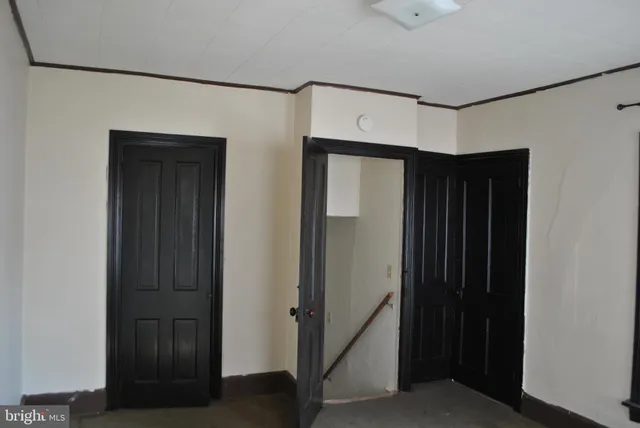 a view of hallway with wooden floor