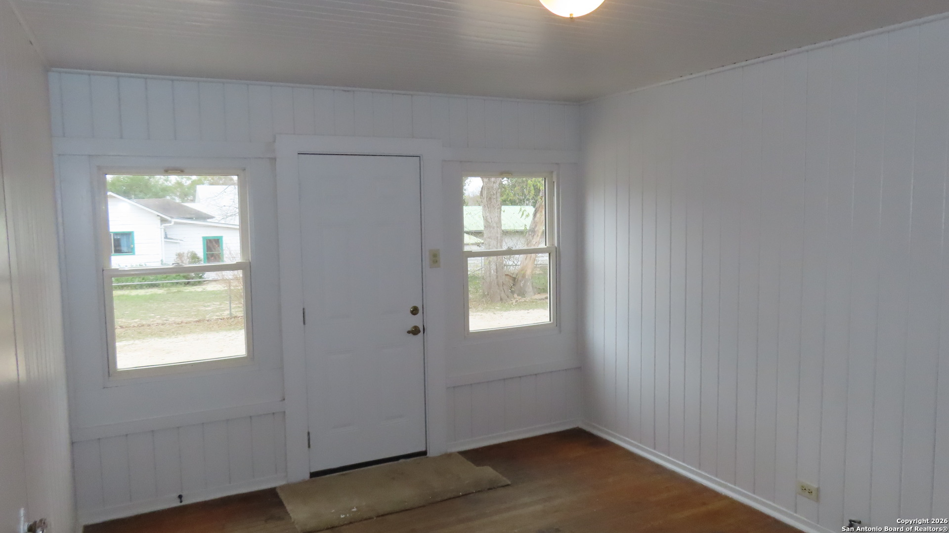 3423 South WW White Road San Antonio, TX 78222 - Photo 15 of 20 a view of an empty room with wooden floor and a window