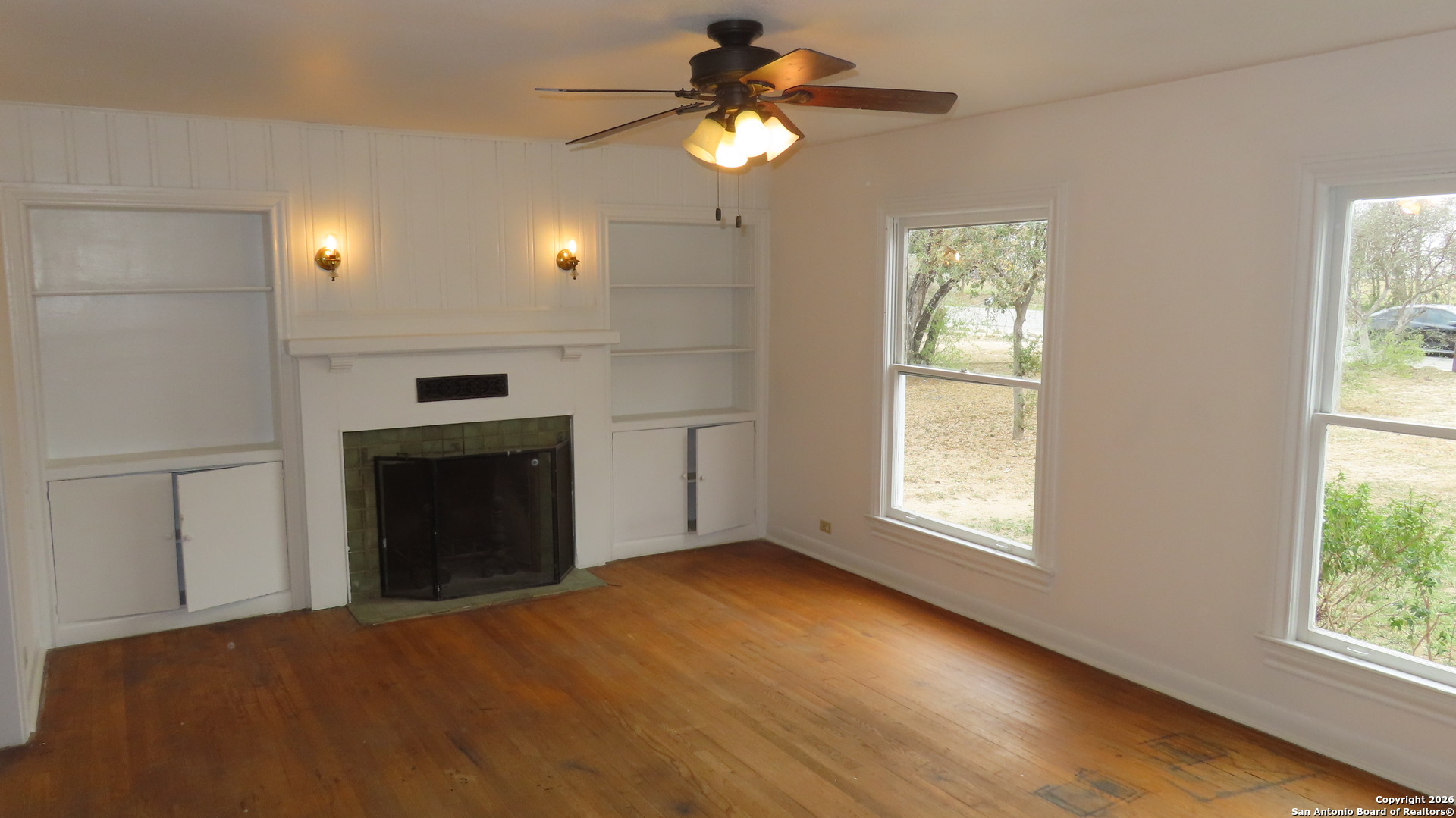 3423 South WW White Road San Antonio, TX 78222 - Photo 3 of 20 a view of an empty room with window and wooden floor