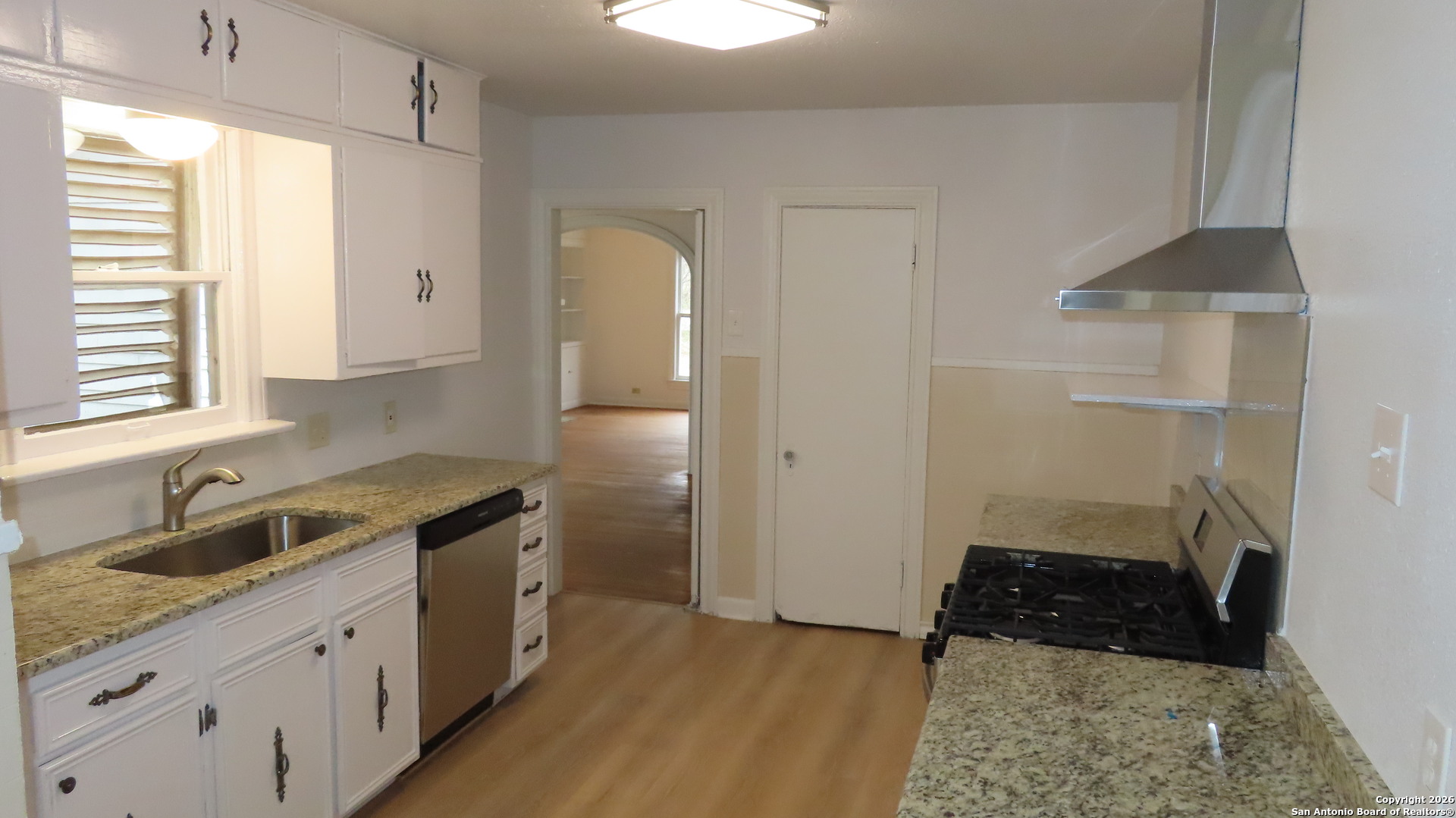 3423 South WW White Road San Antonio, TX 78222 - Photo 8 of 20 a kitchen with a sink and a refrigerator