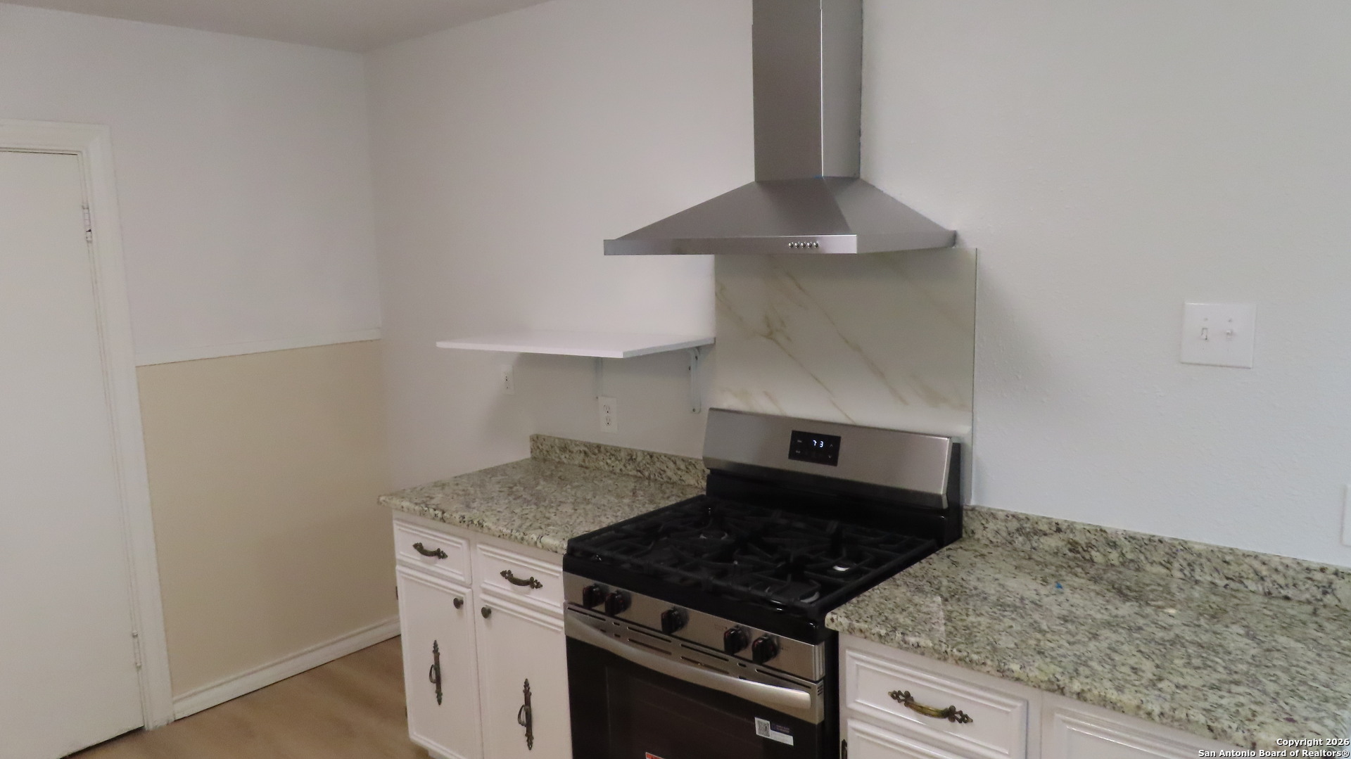 3423 South WW White Road San Antonio, TX 78222 - Photo 9 of 20 a kitchen with granite countertop a stove and a sink