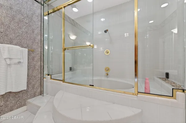 a bathroom with a bathtub and a shower