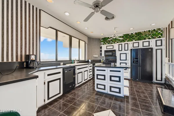 a kitchen with stainless steel appliances a sink cabinets and wooden floor