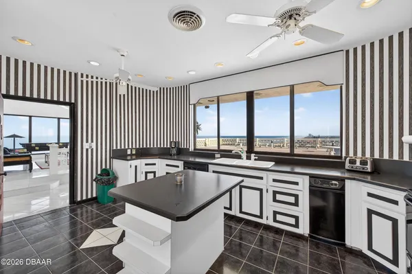 a kitchen with a stove sink and cabinets