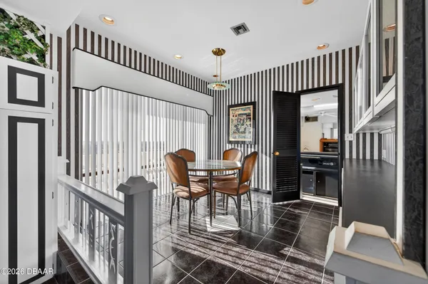 a dining room with furniture window and wooden floor