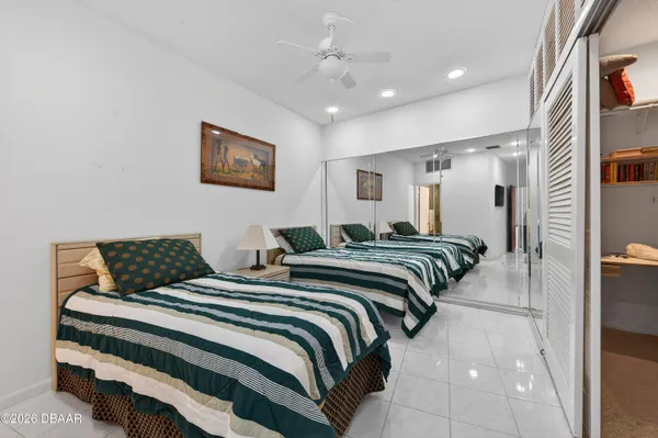 a bedroom with two beds and a walk in closet