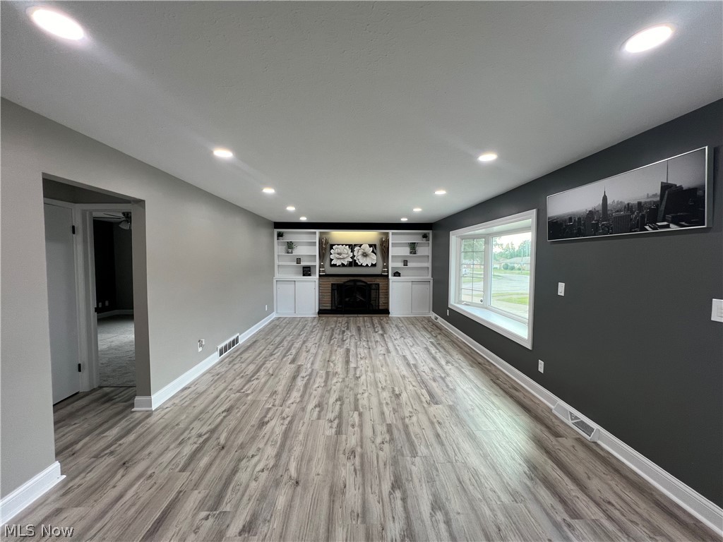 7475 Selwick Drive Parma, OH 44129 - Photo 12 of 29 Unfurnished living room with hardwood / wood-style floors