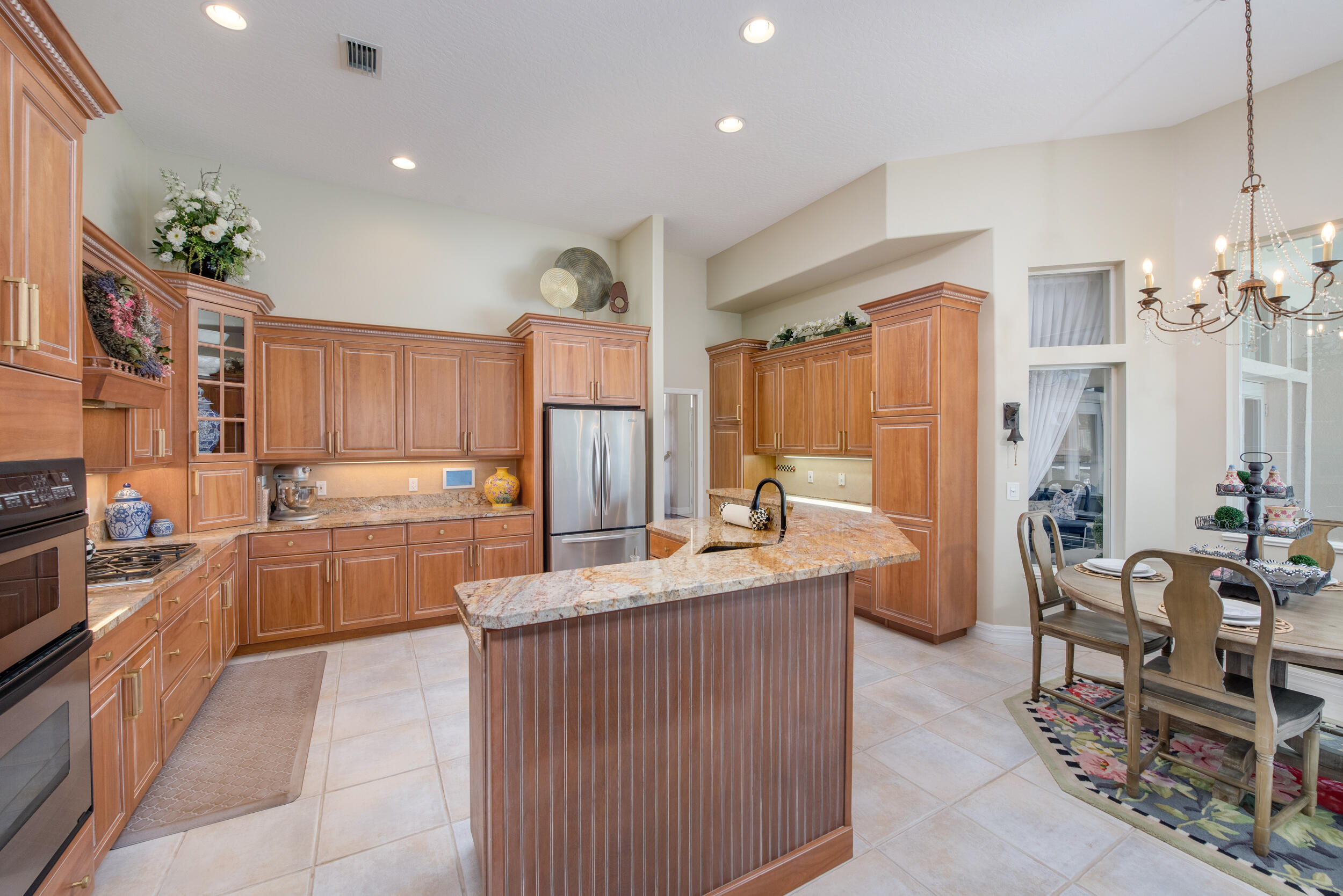 4130 Stoney Point Road Melbourne, FL 32940 - Photo 23 of 40 a large kitchen with kitchen island a large counter top space appliances and cabinets