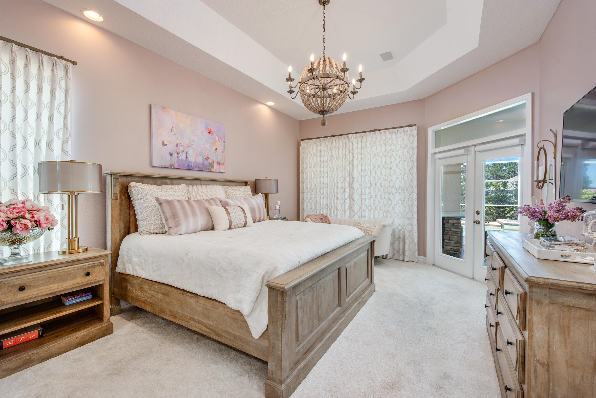 4130 Stoney Point Road Melbourne, FL 32940 - Photo 29 of 40 a bedroom with a bed and a chandelier