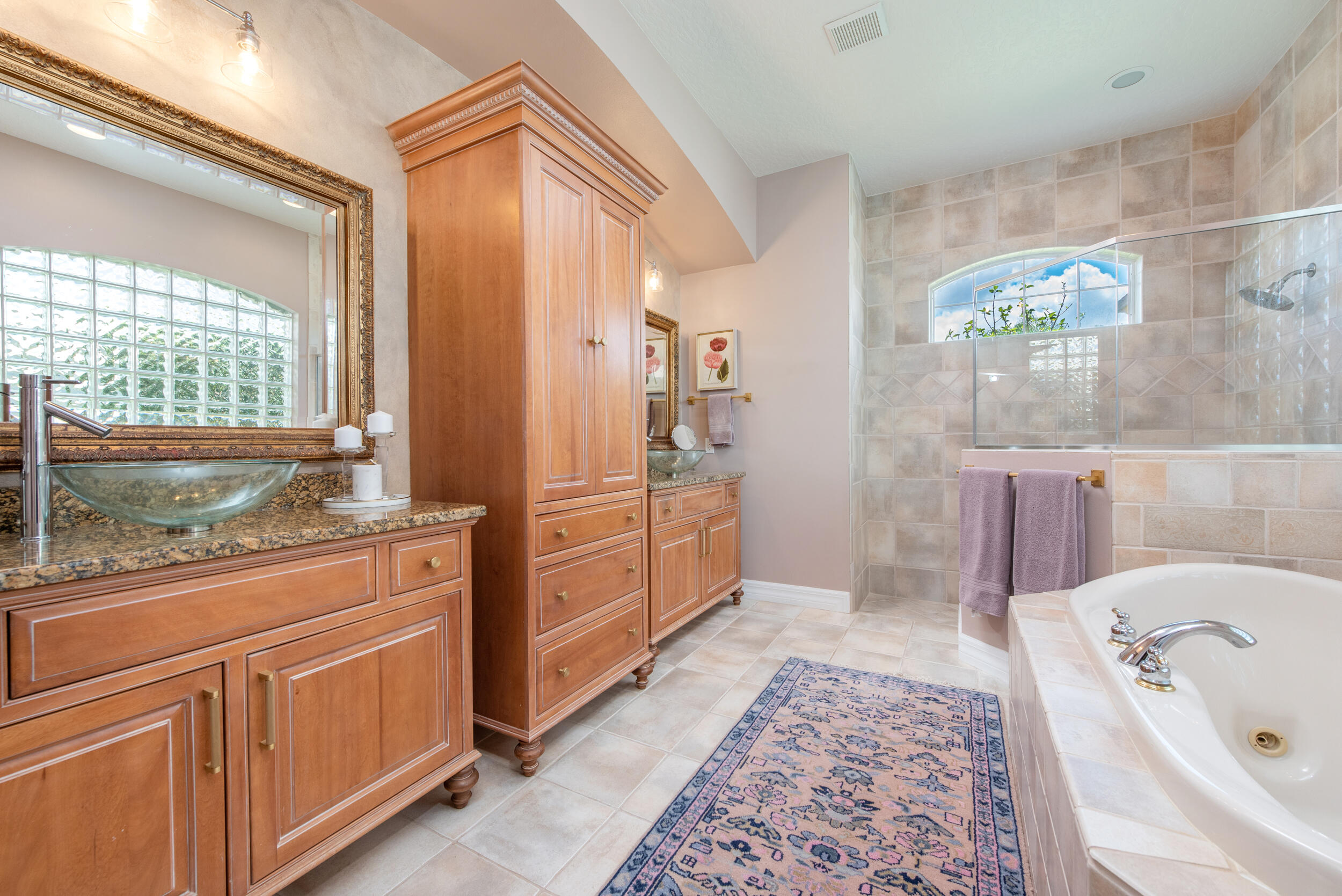 4130 Stoney Point Road Melbourne, FL 32940 - Photo 31 of 40 a bathroom with a tub sink and mirror