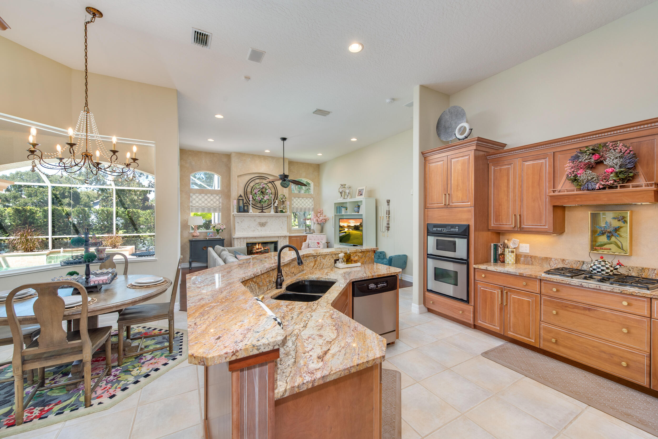 4130 Stoney Point Road Melbourne, FL 32940 - Photo 7 of 40 a view of a kitchen with kitchen island stainless steel appliances wooden floor and a view of living room