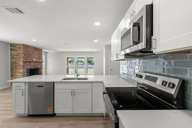 a kitchen with a stove and a sink