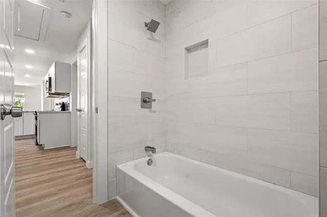 a bathroom with a bathtub and shower