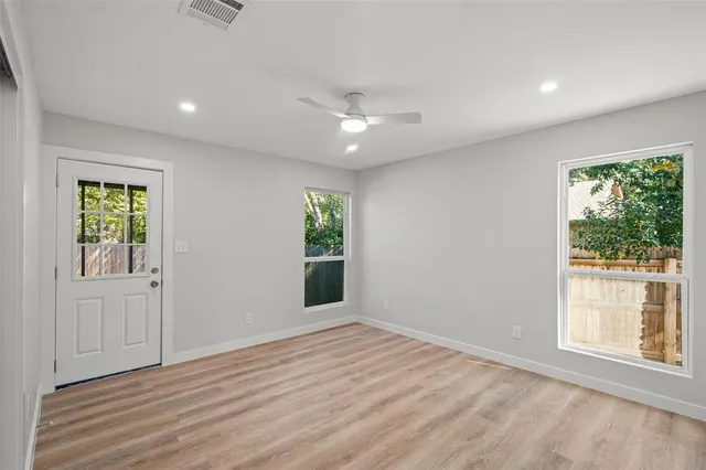 an empty room with windows and outdoor view