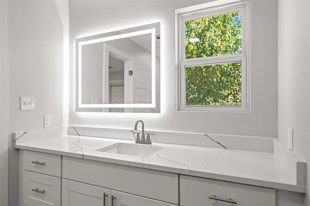a bathroom with a sink and a window