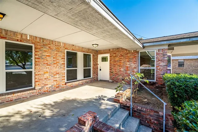 a front view of a house with outdoor seating