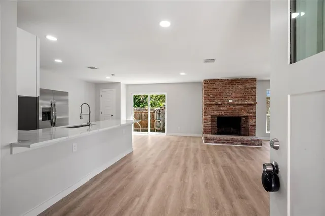 a view of living room with furniture and a fireplace