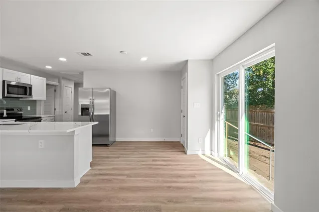 a kitchen with stainless steel appliances a refrigerator and a stove top oven