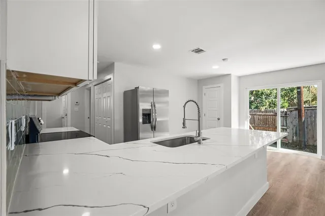 a bedroom with a large bed and a large window