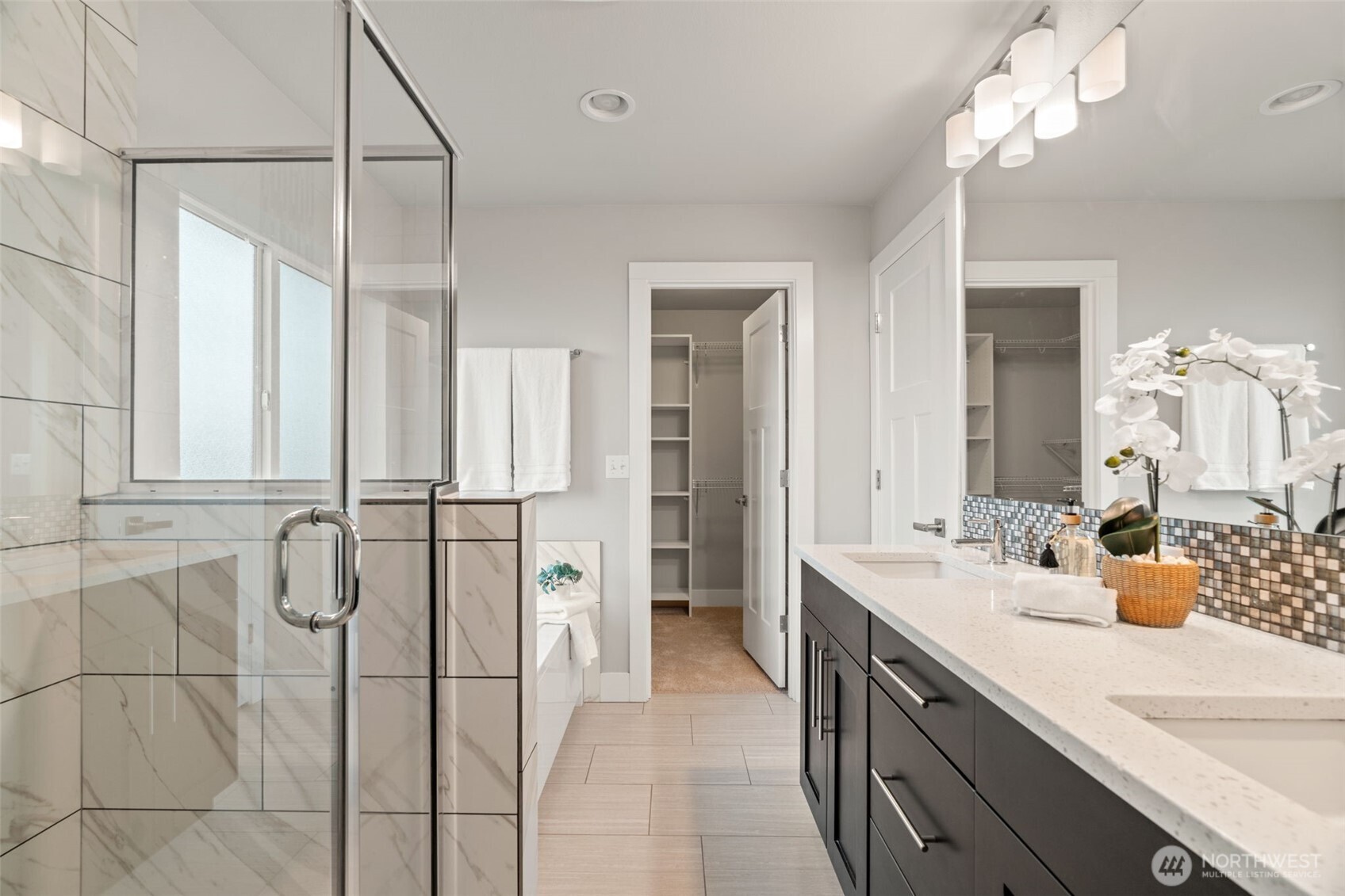 4408 214th Place Southeast Bothell, WA 98021 - Photo 13 of 33 a spacious bathroom with a double vanity sink a large mirror and shower