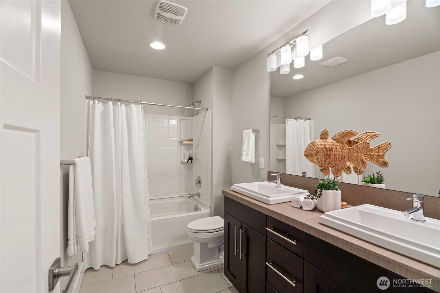 4408 214th Place Southeast Bothell, WA 98021 - Photo 21 of 33 a spacious bathroom with a double vanity sink a large mirror and a shower