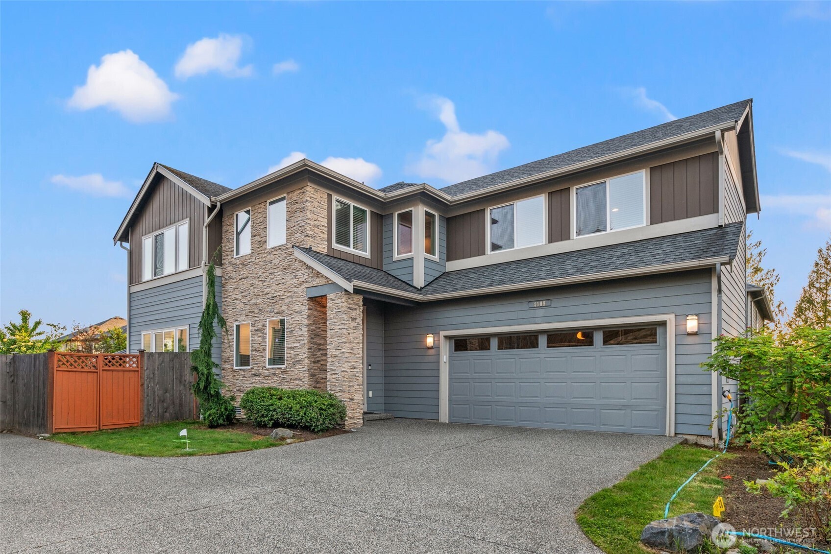 4408 214th Place Southeast Bothell, WA 98021 - Photo 6 of 33 a front view of a house with a yard and garage