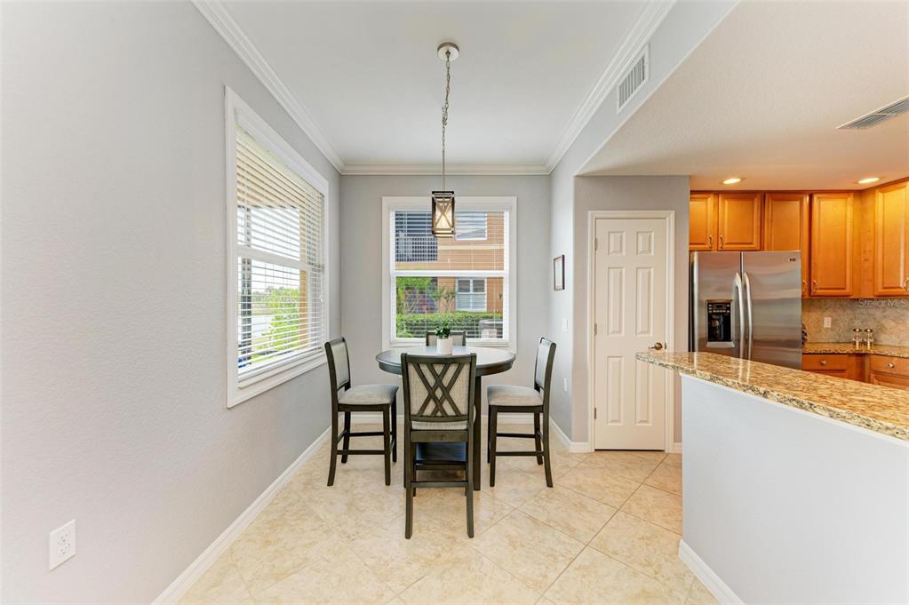 424 Winding Brook Lane, Unit 104 Bradenton, FL 34212 - Photo 12 of 72 a dining room with furniture and windows