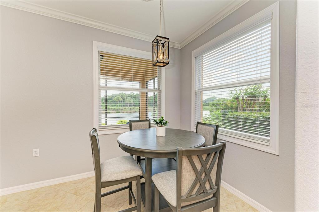 424 Winding Brook Lane, Unit 104 Bradenton, FL 34212 - Photo 13 of 72 a dining room with furniture and window