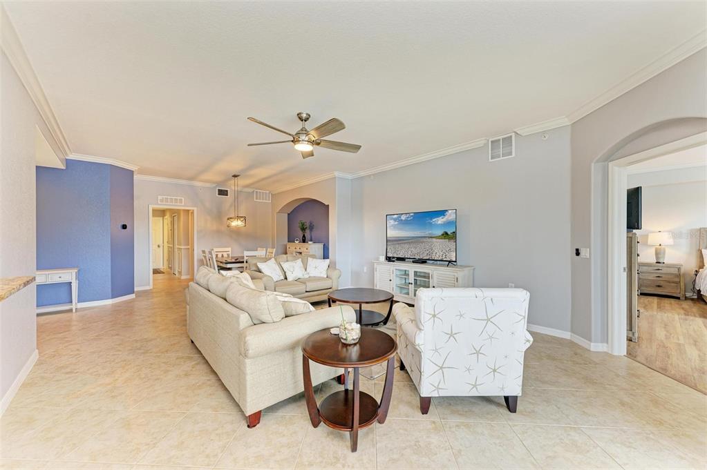 424 Winding Brook Lane, Unit 104 Bradenton, FL 34212 - Photo 14 of 72 a living room with furniture and a chandelier