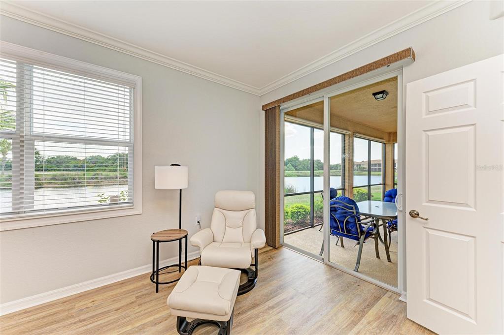 424 Winding Brook Lane, Unit 104 Bradenton, FL 34212 - Photo 19 of 72 a living room with furniture and a large window