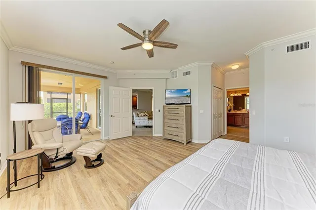 a bedroom with wooden floor closet and ceiling fan
